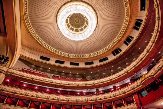 Opera house ceiling with grand chandelier and balconies
 - Powered by Adobe