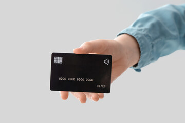 Female hand with credit card on white background, closeup