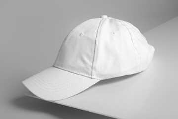 Blank white cap on grey background