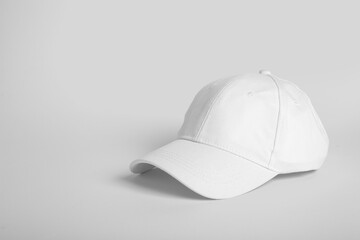 Blank white cap on grey background