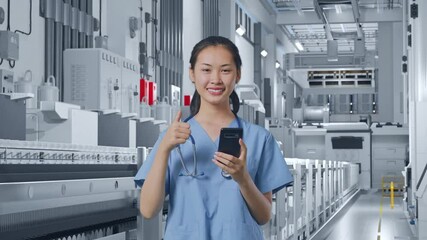 Asian Female Doctor Using Smartphone And Showing Thumbs Up Gesture In Medical Factory
