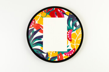Top view of black tray, colorful plate, white card on white background. Exotic plant plate, summer picnic. Flat lay, copy space.