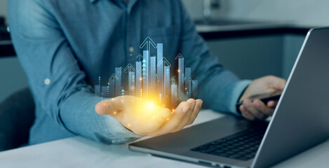 Businessman holding arrow up with graph corporate future growth plan.Business growth graph chart. Financial marketing graph grow chart.