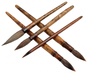 Several art brushes, varying sizes and shapes, arranged in a criss-cross pattern.  Wooden handles with intricate wood grain.  Dark-tipped brush bristles