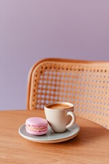 Photograph of an espresso and macaron on the table