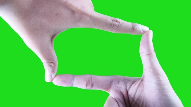 Camera frame gesture isolated on green screen background