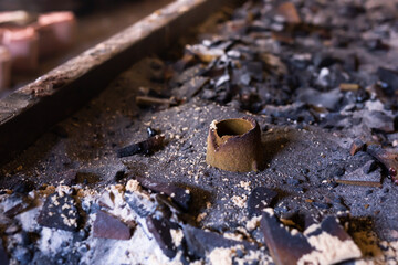 Remains of knocked out casting molds in the workshop of metallurgical plant