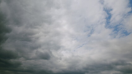 A beautifully dynamic overcast sky with patches of bright blue peeking through the clouds