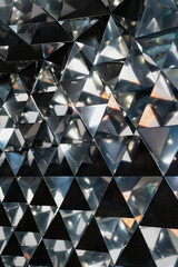 Geometric abstraction of reflective triangular mirrors creating a sense of infinity, depth, and...