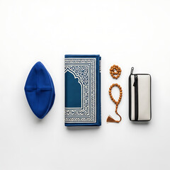 Flat lay of Islamic prayer items: a blue kufi hat, prayer mat, beads, and a white and black wallet, arranged on a white background.