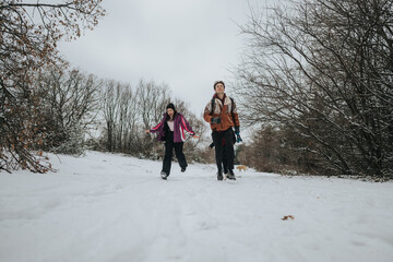 Two friends share a relaxing stroll through a snow-covered park, enjoying the fresh air and tranquil scenery during the winter season, showcasing outdoor friendship and natural beauty.