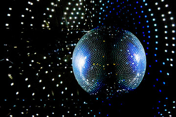 Disco Ball Reflecting Blue and Purple Light. Party, Dance Event, or Nightclub Atmosphere. Copy...