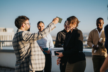 A diverse business team celebrates on a high tower balcony at sunset. The image captures joy and...
