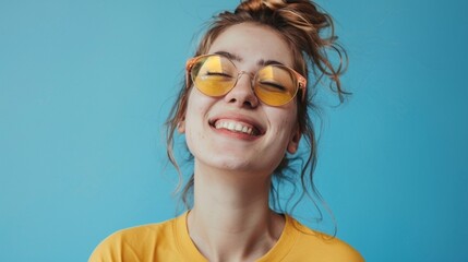 Young woman over isolated blue background smiling
