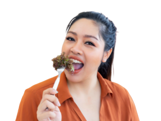 Happy Asian woman enthusiastically eating fresh healthy salad with a fork, promoting wholesome nutrition, healthy lifestyle, diet, and vegetarian food choices , isolated on a transparent background