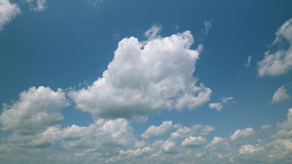 Time lapse. A Beautiful Blue Sky adorned with Fluffy White Clouds that inspire feelings of peace and serenity