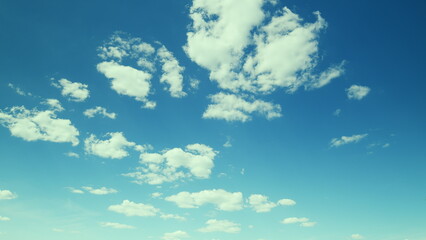 A Beautiful Blue Sky with Soft, Fluffy Clouds that Create a Serene Atmosphere Above