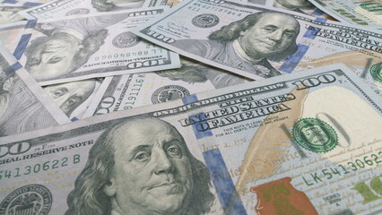 A closeup view of stacks consisting of hundred dollar bills arranged neatly on display