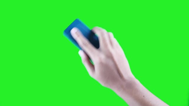 Right hand wiping whiteboard with blue eraser isolated on green screen background