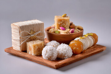 Fototapeta premium Beautiful rakhi and box of dry fruits, and a puja thali with a single diya and flowers and sweets in thali