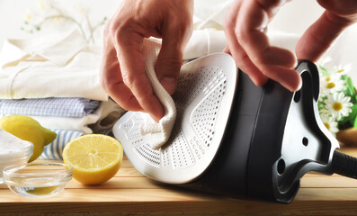 person cleaning steam iron with homemade natural products front view