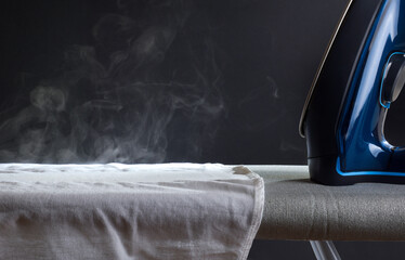 Ironing shirt on ironing board with steam coming out