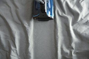 Iron over wrinkled fabric leaving a freshly ironed mark