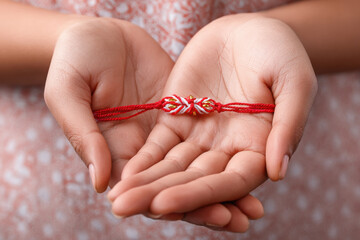 female hand holding rakhi