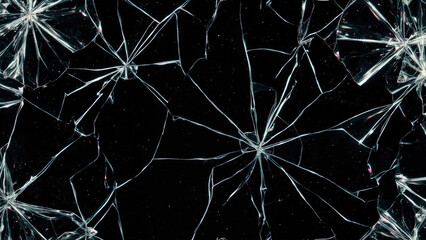 Shattered glass texture on black background with radiating cracks and sharp fragments forming a broken pattern abstract design