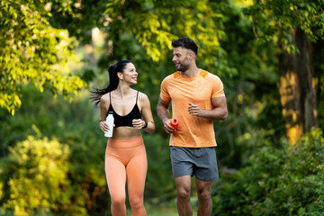 Fitness couple running together in the park.