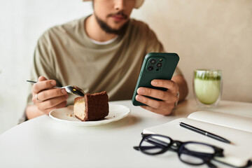Freelancer enjoying matcha and cake while using smartphone in a summer cafe