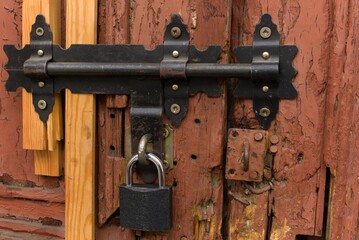 Black padlock on the old gate - 1