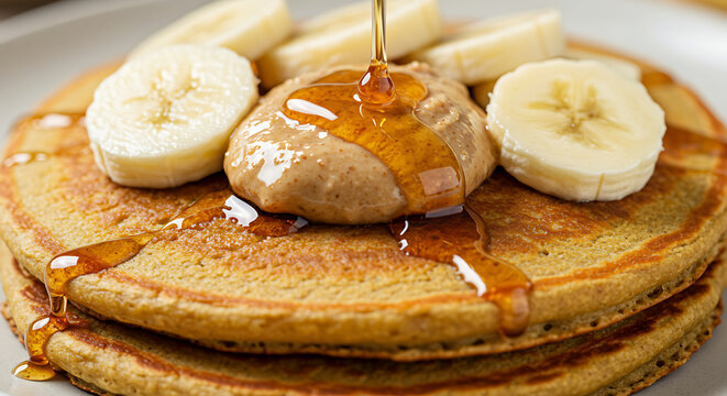 Pancakes stacked and topped with fresh banana slices, perfect for a cozy morning meal. - Powered by Adobe