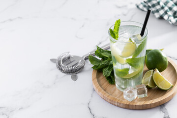 Classic Mojito Cocktail with Lime and Mint on white marble background. Copy space
