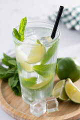 Fototapeta premium Classic Mojito Cocktail with Lime and Mint on white marble background