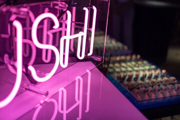 Sushi Bar Display with Neon Glow and Reflections