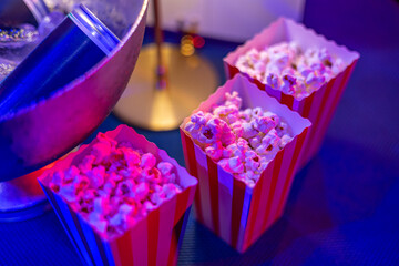 Striped Popcorn Boxes at Neon-Lit Party Table