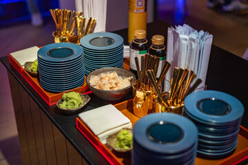 Elegant Sushi Serving Station with Condiments and Utensils