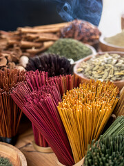Cultural representation of incense sticks and aromatic materials in a spiritual and calming layout.