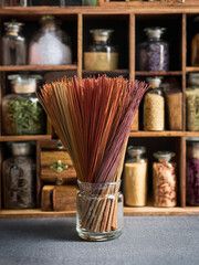 Cultural still life of incense sticks with bowls of herbs and spices in natural lighting.