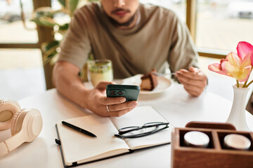 Fototapeta premium Freelancer enjoying matcha and cake while working remotely in a summer cafe