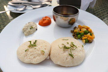 Classic South Indian breakfast. soft idlis served with coconut chutney and flavorful sambar. Idli...