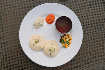 Classic South Indian breakfast. soft idlis served with coconut chutney and flavorful sambar. Idli...
