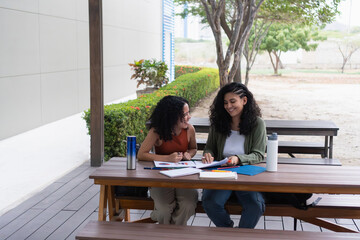 University students collaborating on project outdoors: sharing ideas and learning together