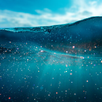 Scenic underwater view with sunbeams penetrating the clear blue ocean. Peaceful, natural seascape perfect for themes of purity, freedom, and marine environment.