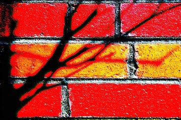 Vibrant brick wall with a dramatic tree shadow