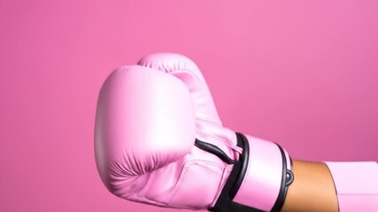 Upward angle of a pink boxing glove on a pink sleeve