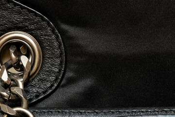 Black leather and fabric texture with metal chain - close up for background or template, bag