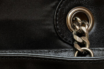 Black leather and fabric texture with metal chain - close up for background or template, bag
