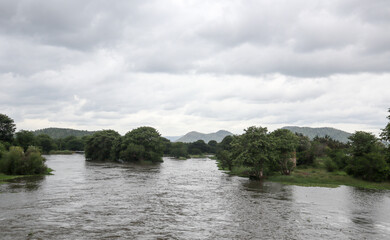 A Picturesque location in the western ghats with trees, river, water, monsoon, mountain range in Karnataka, India.